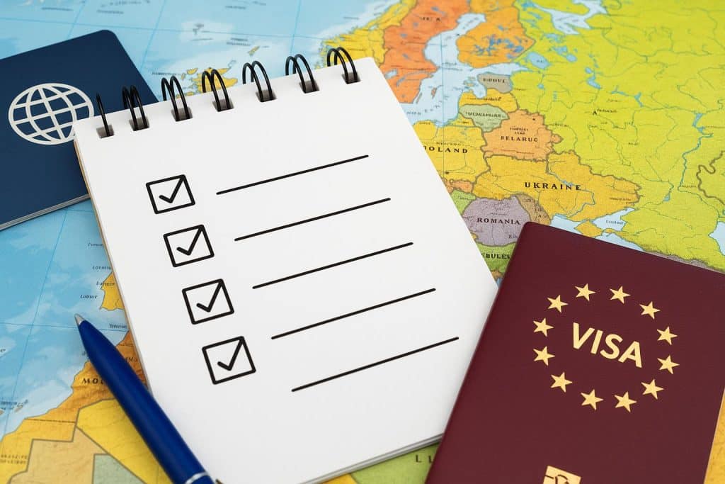 Schengen visa application checklist with passport, documents, and approved stamp on a table