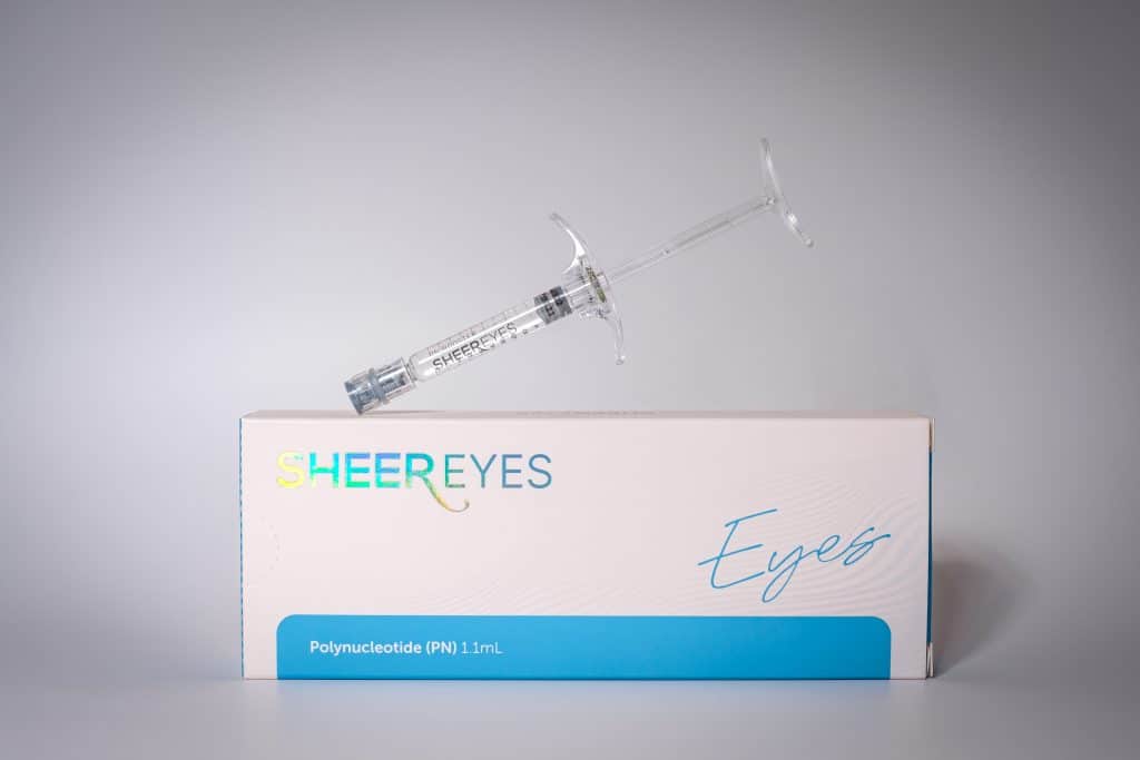 Syringe applying skin booster treatment to under-eye area for dark circles and rejuvenation
