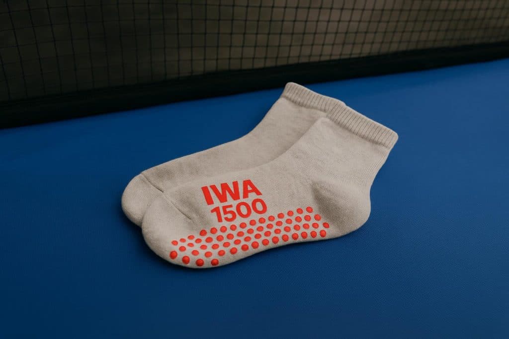 How Should IWA 1500 Trampoline Socks Fit Close-up of IWA 1500 trampoline socks showing proper snug fit on feet for optimal performance