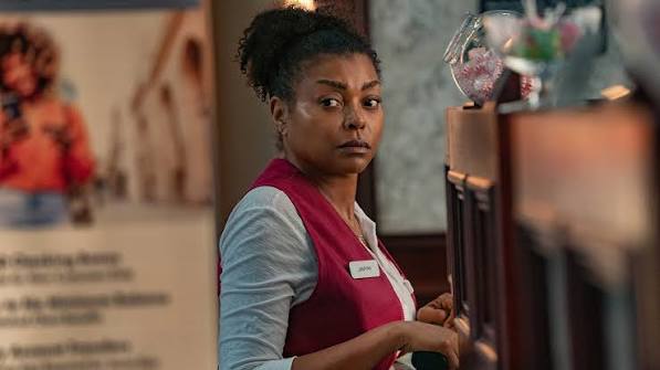 Straw On Netflix: A Game-Changer for Perry Woman in a store wearing a red vest, looking to the side.
