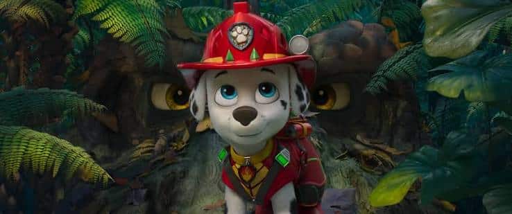Pow Trol: Paw Patrol Characters Shine in Dino Movie Marshall from PAW Patrol in a jungle with dinosaur eyes behind him.