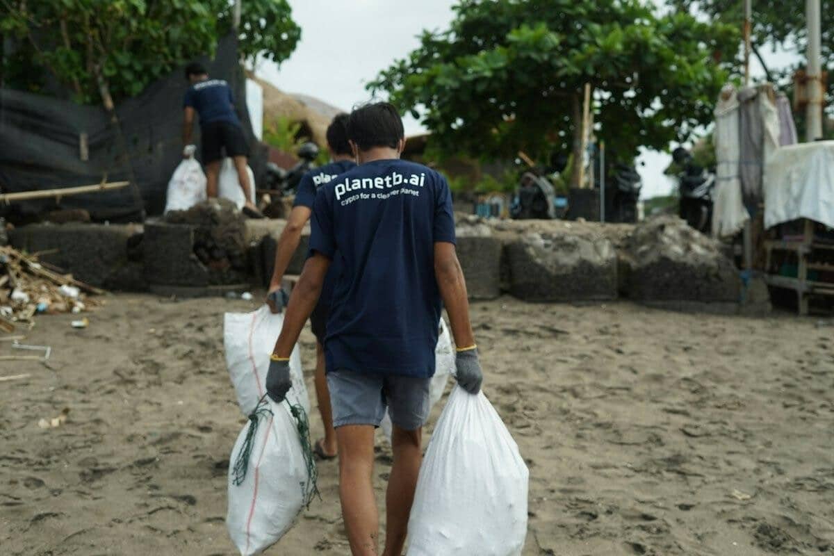 Volunteer carrying bags of collected beach trash